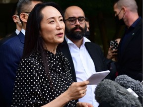 Huawei chief financial officer Meng Wanzhou (C) talks to media at British Columbia Supreme Court after her extradition hearing ended in her favour, in Vancouver British Columbia, Canada on August 18, 2021.