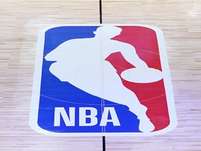 FILE PHOTO: July 30, 2020; Lake Buena Vista, USA; Members of the New Orleans Pelicans and Utah Jazz kneel together around the Black Lives Matter logo on the court during the national anthem before the start of an NBA basketball game.  Mandatory Credit: Ashley Landis/Pool Photo via USA TODAY Sports/File Photo