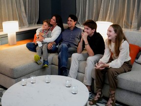 Canada's Liberal Prime Minister Justin Trudeau, accompanied by his wife Sophie Gregoire and his children Ella-Grace, Xavier and Hadrien watch the election coverage on a TV, in Montreal, Quebec, Canada, September 20, 2021.