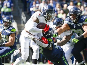 Seattle Seahawks defensive tackle Poona Ford (97) tackles Tennessee Titans running back Derrick Henry (22) during the first quarter at Lumen Field. Mandatory Credit: Joe Nicholson-USA TODAY Sports