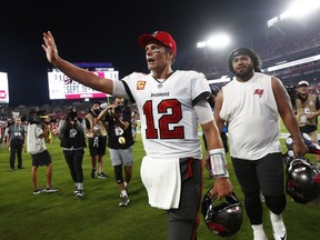 Tampa Bay Buccaneers quarterback Tom Brady (12) and defensive tackle Vita Vea (50) celebrate after defeating the Dallas Cowboys at Raymond James Stadium.