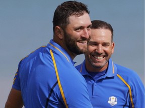 Golf - The 2020 Ryder Cup - Whistling Straits, Sheboygan, Wisconsin, U.S. - September 24, 2021 Team Europe's Jon Rahm and Team Europe's Sergio Garcia celebrate on the 17th green after winning their match during the Foursomes REUTERS/Mike Segar