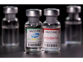 Vials with Pfizer-BioNTech and Moderna coronavirus disease (COVID-19) vaccine labels are seen in this illustration picture taken March 19, 2021.