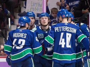 The lessons of Brock Boeser (centre), who came out of the gate slowly to start the 2019-20 season, could be instructive for restricted free agent stars Quinn Hughes and Elias Pettersson.