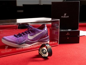 The autographed Kobe Bryant's Hublot King Power "Black Mamba" Chrono Tourbillon watch and Nike Zoom VIII sneaker are pictured.