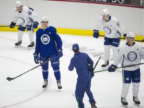 Danila Klimovich (foreground left), Jett Woo (foreground right), Connor Lockheart (background left) and Vasily Podkolzin (background right) during Canucks' rookie camp at Rogers Arena on Friday.