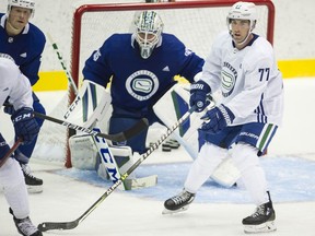 Defenceman Brad Hunt (right) follows the play in front of goalie Thatcher Demko on the first official on-ice day of Canucks training camp at the Abbotsford Centre in Abbotsford on Sept. 23, 2021.