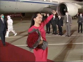 Huawei Technologies Chief Financial Officer Meng Wanzhou waves upon arriving from Canada at Shenzhen Baoan International Airport, in Shenzhen, Guangdong province, China.