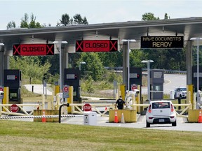 A car approaches one of the few lanes open at the Peace Arch border crossing into the U.S., Tuesday, June 8, 2021, in Blaine, Wash.