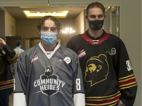 Vancouver Giants goalie Jesper Vikman, right, wears the WHL team's new third jersey that was unveiled Oct. 20 at Pat Quinn's Restaurant in Delta, while forward Ty Thorpe wears another jersey the team will wear at several games this season to pay tribute to various groups.