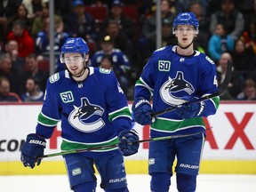 Quinn Hughes, left, and Elias Pettersson of the Canucks during an NHL game against the New York Islanders at Rogers Arena on March 10, 2020, in Vancouver.