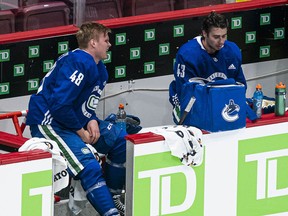 Olli Juolevi (left), seen after a conditioning skate in January before last season, has dropped below the likes of Quinn Hughes (right) in the Canucks' defensive pecking order. Word is he's being shopped around the league by Vancouver.
