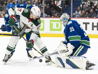 VANCOUVER, BC - OCTOBER 26: Marcus Foligno #17 of the Minnesota Wild shoots against goalie Thatcher Demko #35 of the Vancouver Canucks during the first period of NHL action on October, 26, 2021 at Rogers Arena in Vancouver, British Columbia, Canada.
