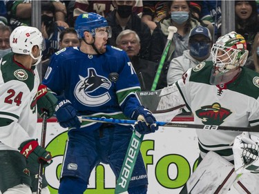 VANCOUVER, BC - OCTOBER 26: Tanner Pearson #70 of the Vancouver Canucks gets hit with the puck in front of goalie Cam Talbot #33 of the Minnesota Wild during the first period of NHL action on October, 26, 2021 at Rogers Arena in Vancouver, British Columbia, Canada. Matt Dumba #24 of the Minnesota Wild tries to help defend on the play.