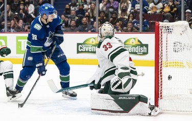 VANCOUVER, BC - OCTOBER 26: Alex Chiasson #39 of the Vancouver Canucks puts the puck past goalie Cam Talbot #33 of the Minnesota Wild for a goal during the second period of NHL action on October, 26, 2021 at Rogers Arena in Vancouver, British Columbia, Canada.
