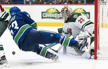 VANCOUVER, BC - OCTOBER 26: Bo Horvat #53 of the Vancouver Canucks falls to the ice after getting stopped in close by goalie Cam Talbot #33 of the Minnesota Wild during the second period of NHL action on October, 26, 2021 at Rogers Arena in Vancouver, British Columbia, Canada.