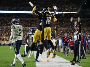 Najee Harris #22 of the Pittsburgh Steelers and Diontae Johnson #18 celebrate Harris' touchdown during the second quarter Seahawks at Heinz Field on October 17, 2021 in Pittsburgh, Pennsylvania.