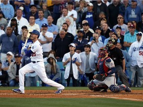 Cody Bellinger #35 of the Los Angeles Dodgers hits a 3-run home run during the 8th inning of Game 3 of the National League Championship Series against the Atlanta Braves at Dodger Stadium on October 19, 2021 in Los Angeles, California.