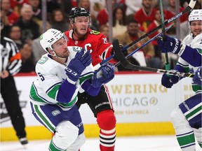 Tucker Poolman (left), battling Blackhawks captain Jonathan Toews for the puck during a game in Chicago last season, had to deal with a series of migraines.