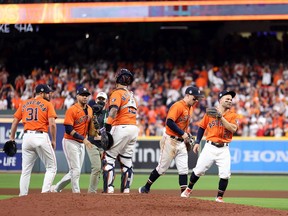 The Houston Astros celebrate the team's 7-2 win against the Atlanta Braves in Game Two of the World Series at Minute Maid Park on October 27, 2021 in Houston, Texas.