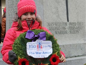 2018: Megan Mantha  holds the wreath she laid on behalf of The War Amps at the cenotaph during Remembrance Day ceremonies