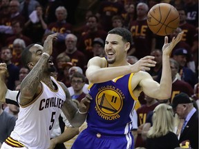Klay Thompson #11 of the Golden State Warriors keeps control of the ball while defended by J.R. Smith #5 of the Cleveland Cavaliers during the fourth quarter in Game 4 of the 2016 NBA Finals at Quicken Loans Arena on June 10, 2016 in Cleveland, Ohio.