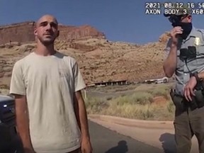 This August 12, 2021, still image from a police bodycam released by the Moab City Police Department in Utah, shows Brian Laundrie (L) speaking with police as they responded to an altercation between Laundrie and his girlfriend Gabrielle Petito.