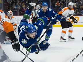 Vancouver Canucks forward Conor Garland gets tripped up against the Philadelphia Flyers at Rogers Arena.