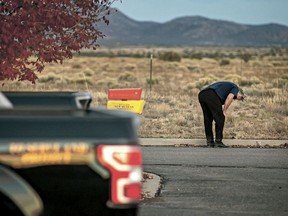 A distraught Alec Baldwin lingers in the parking lot outside the Santa Fe County Sheriff's Office in Santa Fe, N.M., after he was questioned about a shooting on the set of the film "Rust" on the outskirts of Santa Fe, Thursday, Oct. 21, 2021. Baldwin fired a prop gun on the set, killing cinematographer Halyna Hutchins and wounding director Joel Souza.