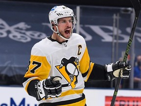Pittsburgh Penguins center Sidney Crosby celebrates the goal by Pittsburgh Penguins left wing Jake Guentzel (not pictured) against the New York Islanders during the first period in game six of the first round of the 2021 Stanley Cup Playoffs at Nassau Veterans Memorial Coliseum in Uniondale, N.Y., May 26, 2021.