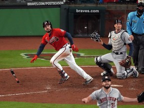 Atlanta Braves catcher Travis d’Arnaud hits a home run against the Houston Astros during Game 3 of the World Series at Truist Park in Atlanta on Friday, Oct. 29, 2021.