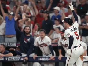 Oct 12, 2021; Cumberland, Georgia, USA; Atlanta Braves first baseman Freddie Freeman (5) gestures as he rounds the bases after hitting a home run during the eighth inning against the Milwaukee Brewers in game four of the 2021 ALDS at Truist Park. Mandatory Credit: Dale Zanine-USA TODAY Sports