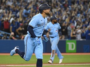 Toronto Blue Jays center fielder George Springer (4) rounds the bases after hitting a grand slam home run against Baltimore Orioles in the third inning at Rogers Centre.