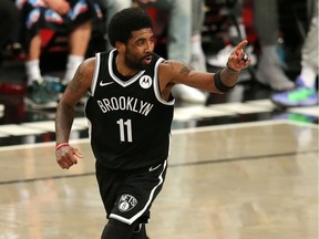 Brooklyn Nets point guard Kyrie Irving reacts after making a basket against the Milwaukee Bucks during the second quarter of game one in the Eastern Conference semifinals of the 2021 NBA Playoffs at Barclays Center.