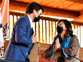 Canada's Prime Minister Justin Trudeau and Kukpi7 Rosanne Casimir react after exchanging gifts at the Tk'emlups PowWow Arbour in B.C., Oct. 18, 2021.