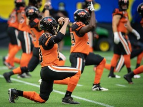 B.C. Lions quarterback Michael Reilly stretches before a CFL football game against the Edmonton Elks in Vancouver, on Thursday Aug. 19, 2021.