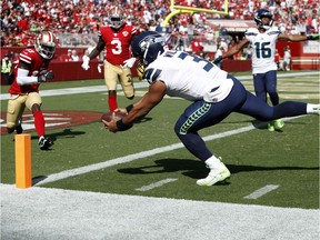 Seattle Seahawks quarterback Russell Wilson (3) dives to score a touchdown during the third quarter against the San Francisco 49ers at Levi's Stadium.