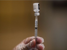 A nurse fills a syringe with Pfizer vaccine as mobile vaccination teams begin visiting every Los Angeles Unified middle and high school campus to deliver first and second doses of the coronavirus disease (COVID-19) vaccines in Los Angeles, California, U.S., August 30, 2021. REUTERS/Mike Blake