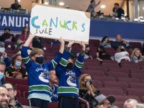 Vancouver Canucks fans cheer on their team as they take on the Winnipeg Jets in NHL pre-season hockey action on Sunday, Oct. 3, 2021. Fans returned to Rogers Arena for the first time at 50 per cent capacity after 18 months away due to COVID-19 retractions.