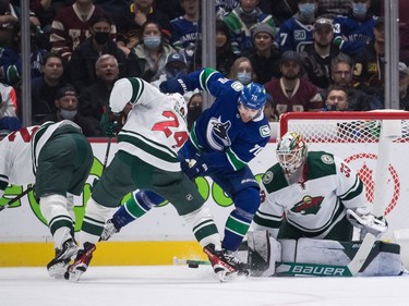 Vancouver Canucks' Tanner Pearson (70) and Minnesota Wild's Matt Dumba (24) vie for the puck in front of goalie Cam Talbot (33) during the first period of an NHL hockey game in Vancouver, on Tuesday, October 26, 2021.