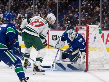 Vancouver Canucks goalie Thatcher Demko (35) stops Minnesota Wild's Nick Bjugstad (27) during the first period of an NHL hockey game in Vancouver, on Tuesday, October 26, 2021.