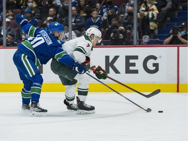 Oct 26, 2021; Vancouver, British Columbia, CAN; Vancouver Canucks forward Elias Pettersson (40) checks Minnesota Wild forward Nico Sturm (7) in the second period at Rogers Arena. Mandatory Credit: Bob Frid-USA TODAY Sports