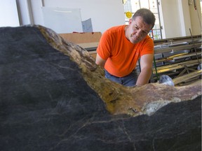 Artist D'Arcy Basil displays the slab of jade he will be using to carve a Kamloops Residential School monument.