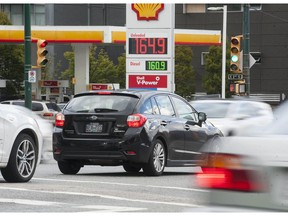 Motorists at Main Street and East 2nd Avenue pass a gas station advertising prices that have not been so high for several months, in Vancouver.