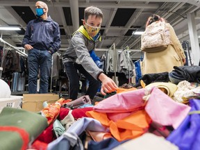 Alec Hughes, 12, looks for some fabric during the annual Vancouver Opera props and costume sale in Vancouver on Sunday.