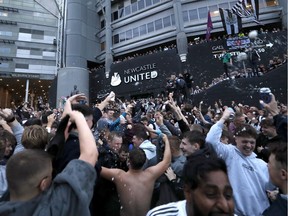 October 7, 2021 Fans react outside the stadium after Newcastle United announced takeover.