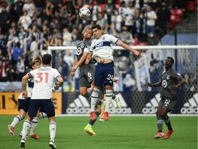 Minnesota United FC midfielder Osvaldo Alonso (6) goes up for a header against Vancouver Whitecaps forward Brian White (24) during the first half at B.C. Place.