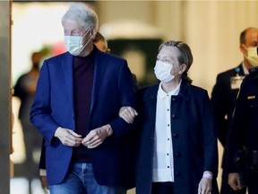 Former U.S. President Bill Clinton, accompanied by his wife, former Secretary of State Hillary Clinton, walks out of University of California Irvine Medical Center, in Orange, California, U.S. October 17, 2021.