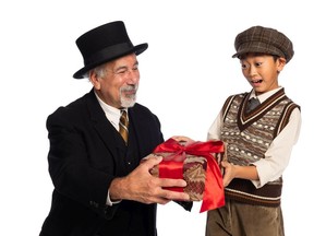‘I joke that I’ve played every role in A Christmas Carol save for Tiny Tim,’ says actor David (Scrooge) Adams, here in character presenting a gift to Rickie Wang’s Tiny Tim. ‘… But I think this is one of the best versions because of how it brings out the fact that Scrooge isn’t just a mean old geezer, he’s a broken man due to his experiences.’
