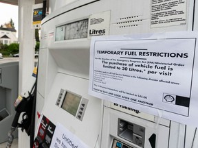 Signs indicating temporary fuel restrictions and a lack of gasoline at a gas station in Vancouver last week.